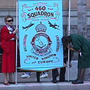More than willing helpers Barbara Woods and granddaughter Erica help readying the 460 squadron banner.