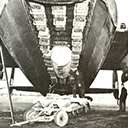 Lancaster bombed up with 4000lb (Cookie) blast bomb surrounded by canisters of incendiaries with armourer arming the cookie.