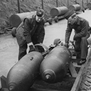 The Armourers loading 500lb bombs from the bomb dump. In the background 4000lb cookies lined up ready for loading.
