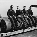 An indication of the size of the 4000lb (Cookie) Bomb shows Bill Gourlay (Nav) and 3 gunners from Vic Neale's crew. Photo taken of the Cookie to be loaded onto K2 in May 1944.