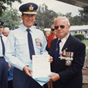 Laurie Woods, DFC (Qld/Pres), presents certificate to RAAF Amberley.
